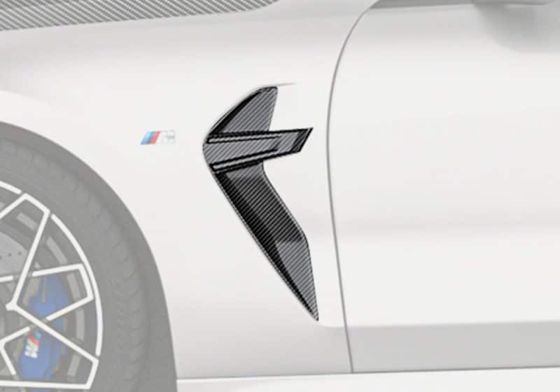 A complete side view of the BMW M8 F93, showcasing the Carbon Fiber Fender Trims as part of the overall luxurious and sporty look